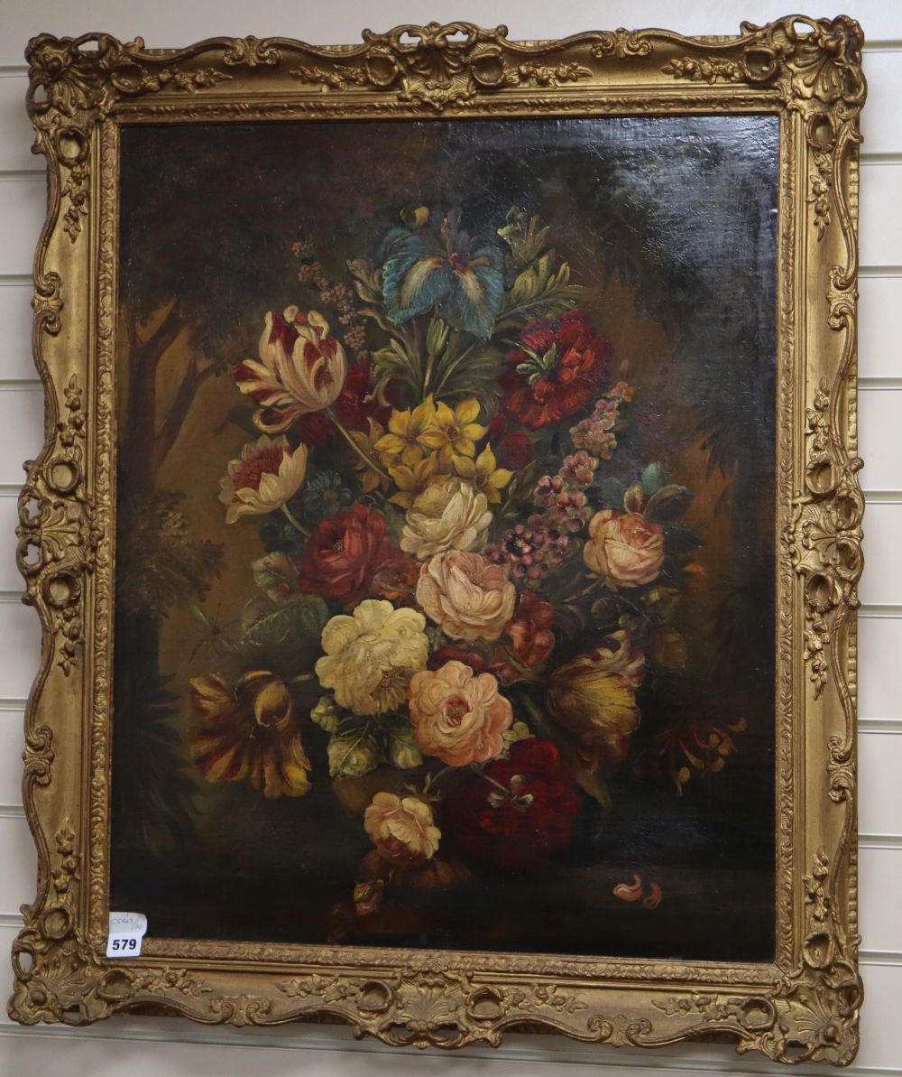 19th century English School, oil on canvas, Still life of flowers in a vase on a ledge, woodland beyond, 74 x 61cm